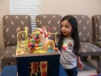 Child playing with bead maze toy in the waiting room