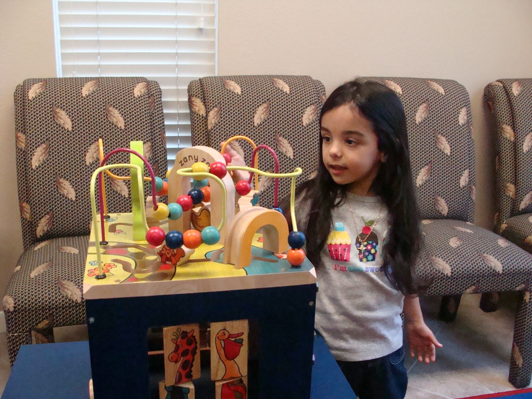 Child playing with bead maze toy in the waiting room