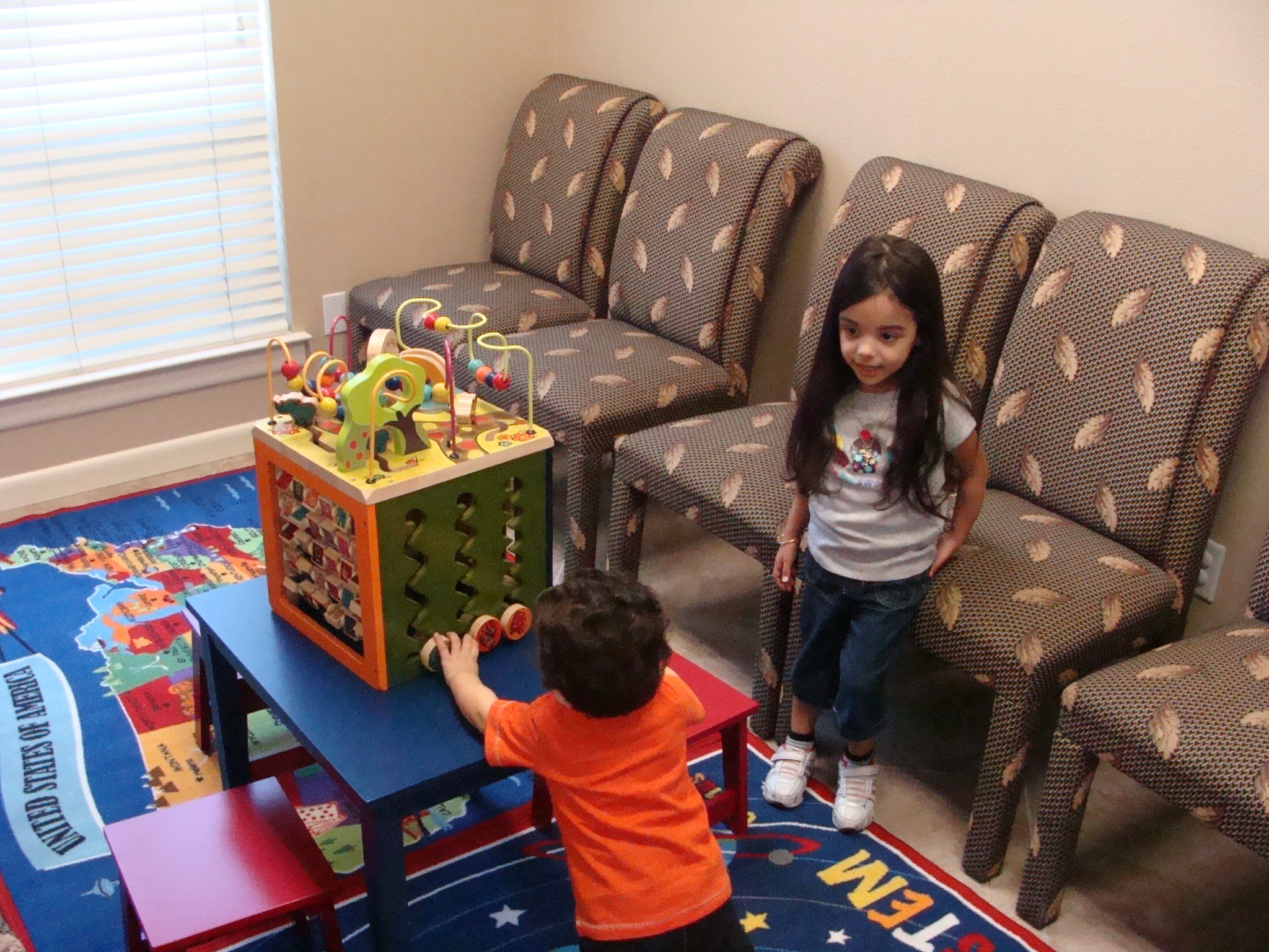 Two children playing together in the waiting room