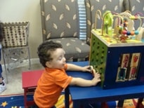 Young child playing at the activity table in the waiting room