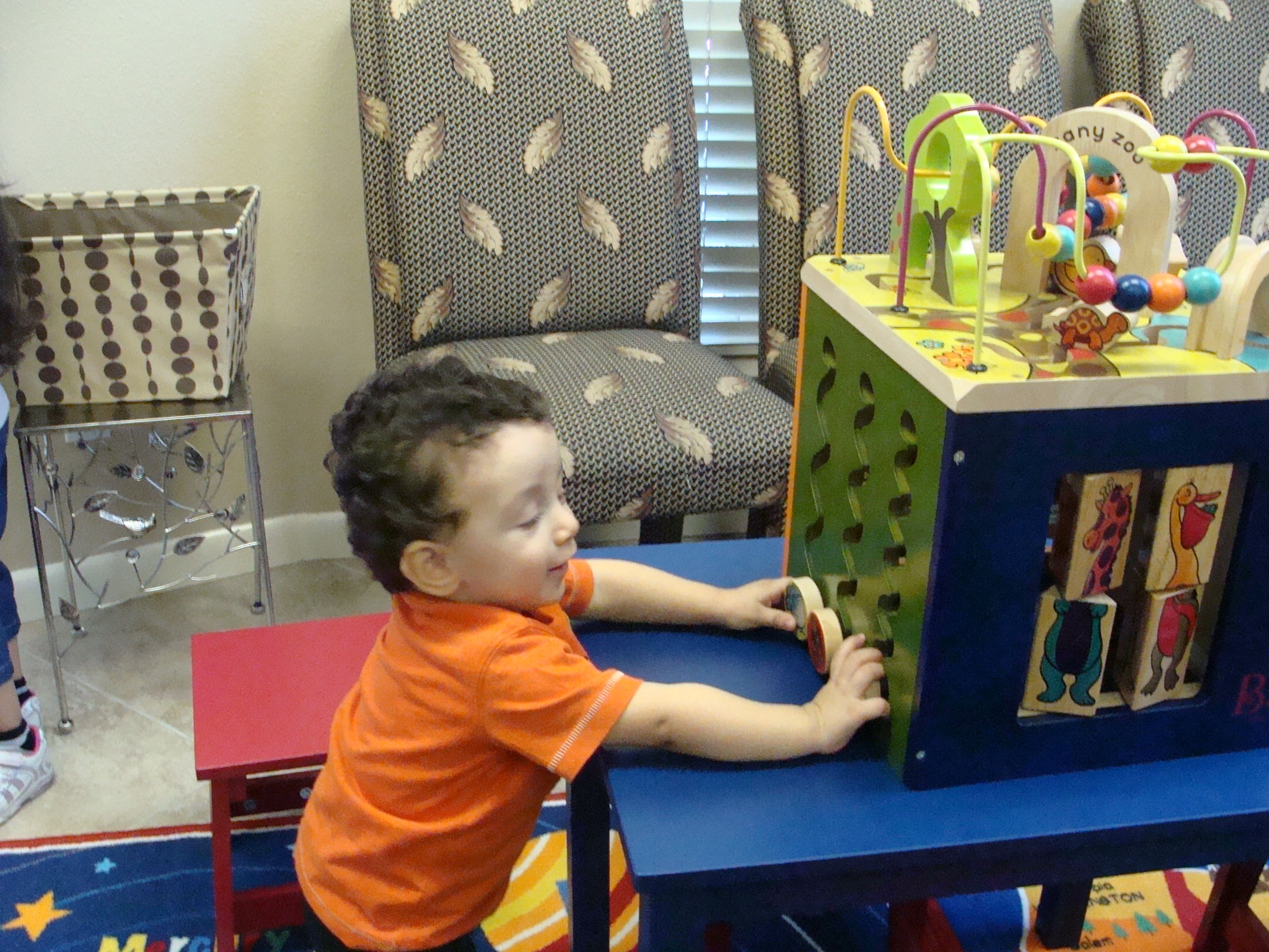 Young child playing at the activity table in the waiting room