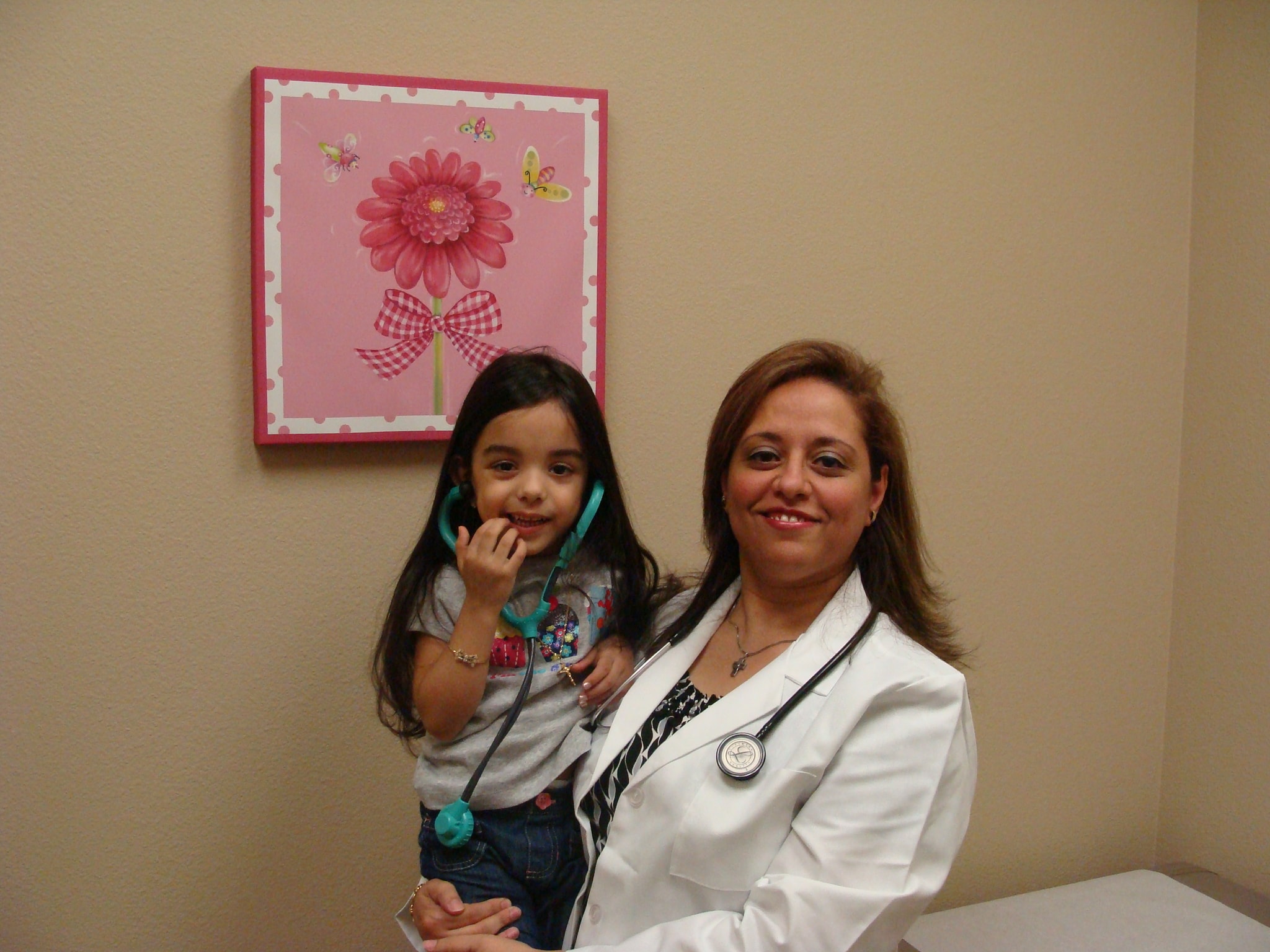 Dr. Attia with a young patient in the exam room