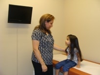 Staff member with a child patient in the exam room