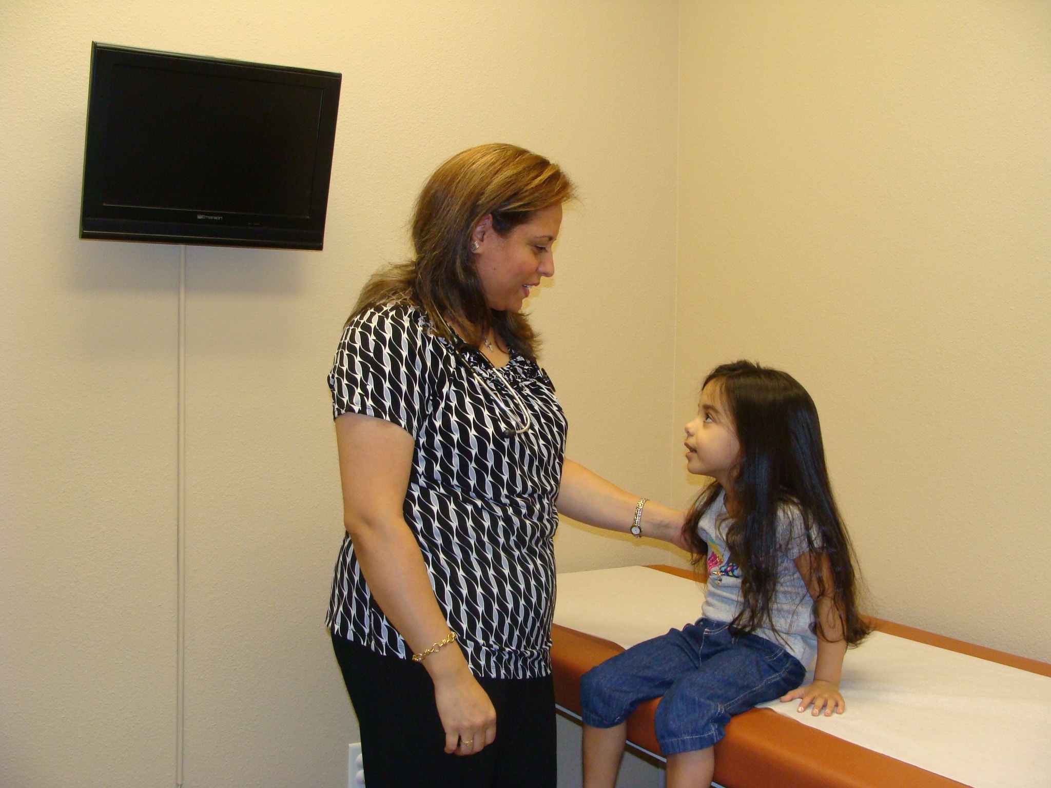 Staff member with a child patient in the exam room